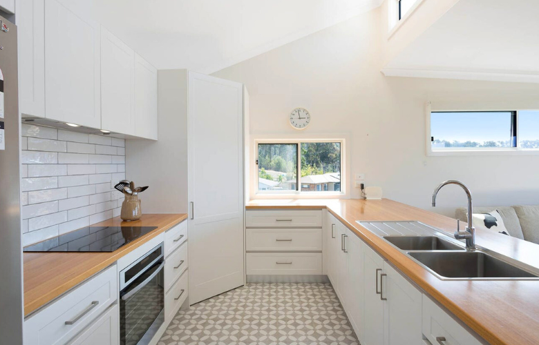 Blackbutt timber benchtop and Templar Herald Grey floor tiles